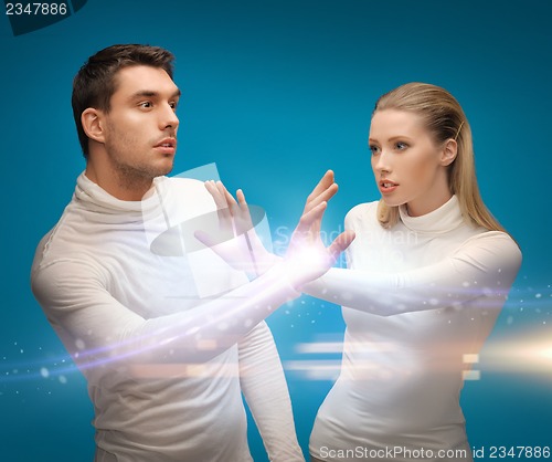Image of man and woman working with magic