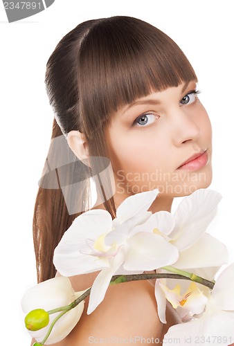 Image of lovely woman with orchid flower