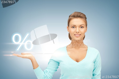 Image of woman showing sign of percent in her hand