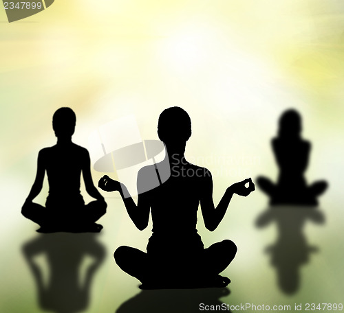 Image of silhouettes of women practicing yoga lotus pose