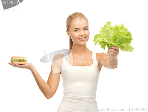 Image of woman with green leaves and hamburger