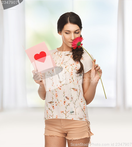 Image of young woman holding flower and  postcard