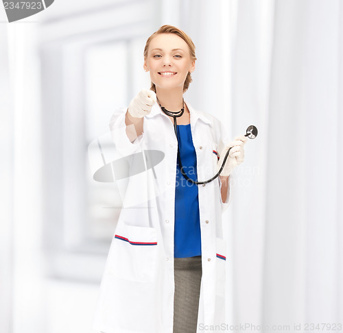 Image of attractive female doctor pointing her finger