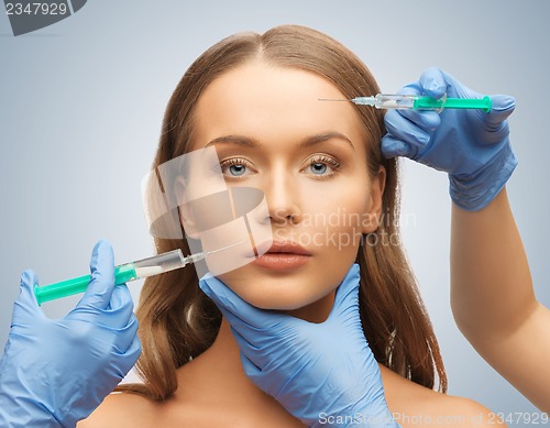 Image of woman face and beautician hands