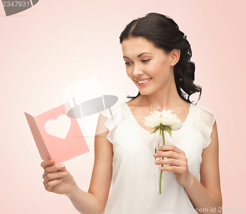 Image of young woman holding flower and postcard