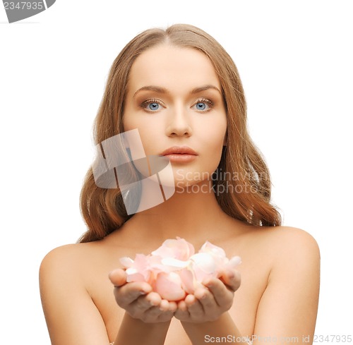 Image of beautiful woman with rose petals