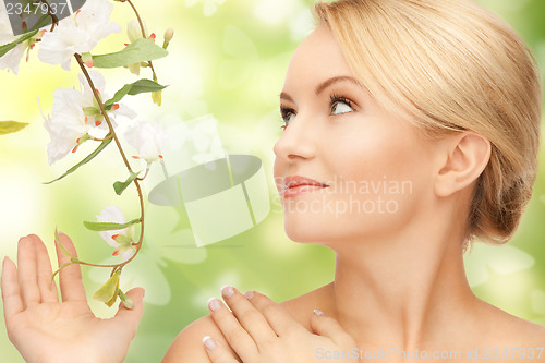 Image of woman with flowers on twig and butterflies