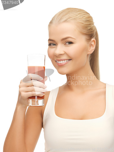 Image of woman holding glass of tomato juice