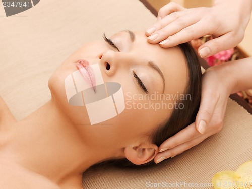 Image of beautiful woman in massage salon