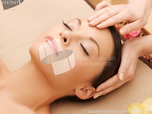 Image of beautiful woman in massage salon