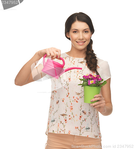 Image of housewife with flower in pot and watering can