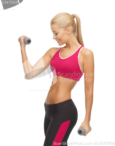 Image of young sporty woman with light dumbbells