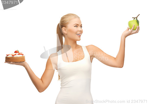 Image of sporty woman with apple and cake