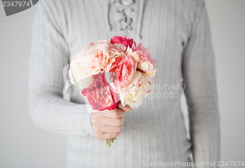 Image of man holding bouquet of flowers