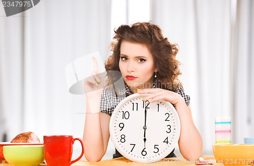 Image of young attractive woman in the kitchen