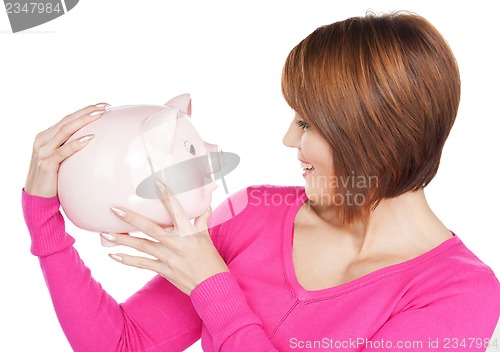Image of lovely woman with piggy bank