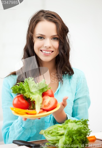 Image of woman in the kitchen with vegetables