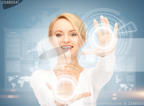 Image of businesswoman touching virtual screen