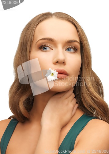 Image of woman with camomile in mouth