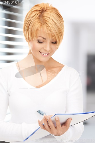 Image of attractive businesswoman with notebook