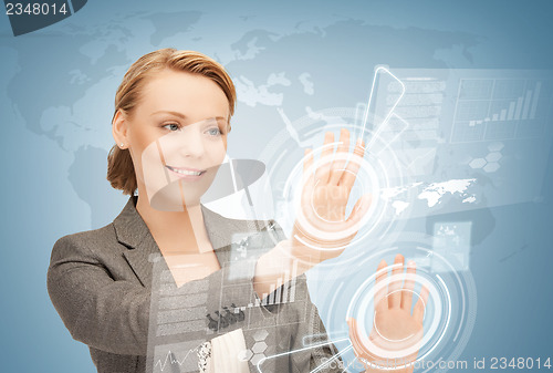 Image of businesswoman touching virtual screen