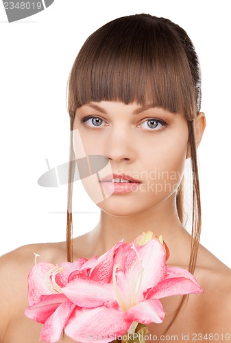 Image of lovely woman with lily flower