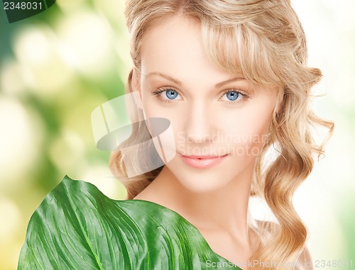 Image of woman with green leaf