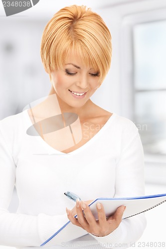 Image of attractive businesswoman with notebook