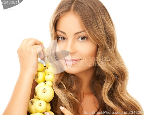 Image of lovely woman with apple twig
