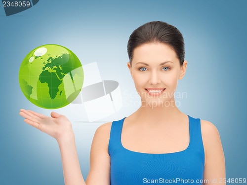 Image of woman holding green globe on her hand