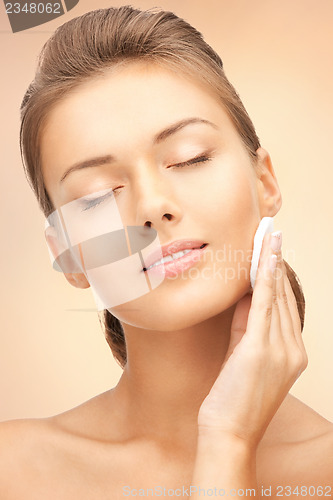 Image of beautiful woman with cotton pad