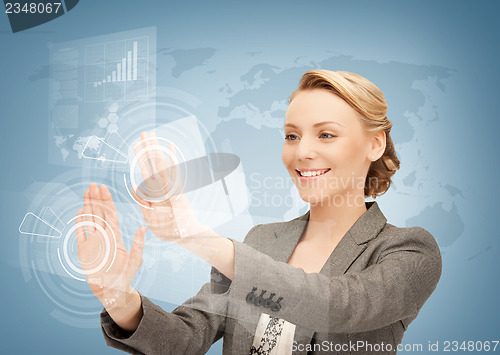 Image of businesswoman touching virtual screen