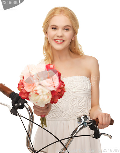 Image of country girl with bicycle and flowers