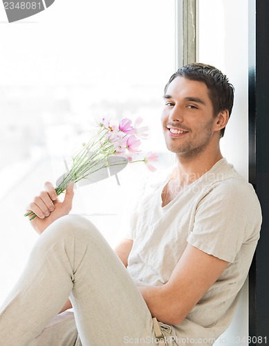 Image of man holding bouquet of flowers