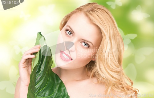 Image of woman with green leaf and butterflies