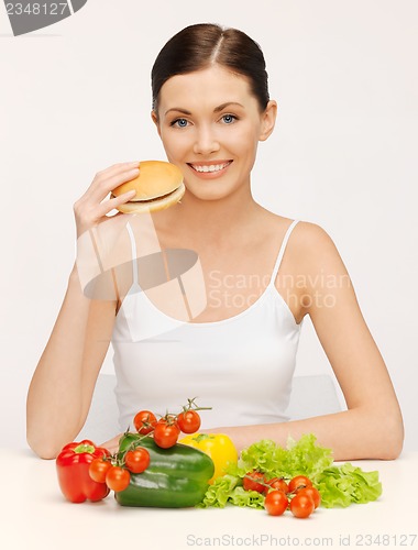 Image of woman with hamburger and vegetables