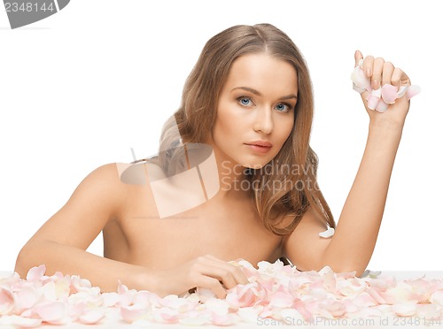 Image of beautiful woman with rose petals