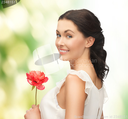 Image of young and beautiful woman with flower