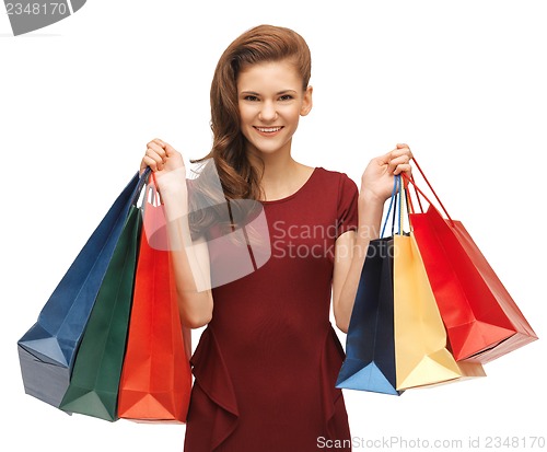 Image of teenage girl in red dress with shopping bags