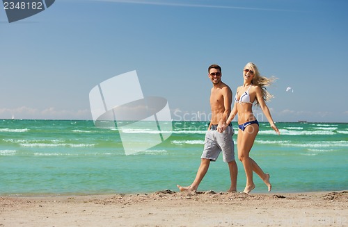 Image of couple walking on the beach