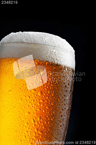 Image of glass of beer on dark blue background