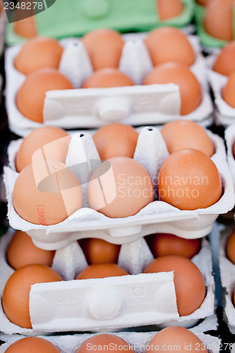 Image of group of eggs in carton box closeup market outdoor