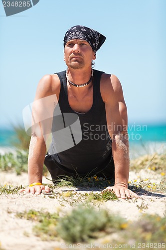 Image of adult healthy man doing pilates yoga exercise 