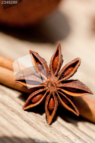 Image of anice cinnamon and bauble christmas decoration in gold