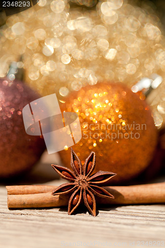 Image of anice cinnamon and bauble christmas decoration in gold