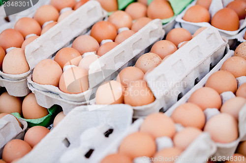 Image of group of eggs in carton box closeup market outdoor