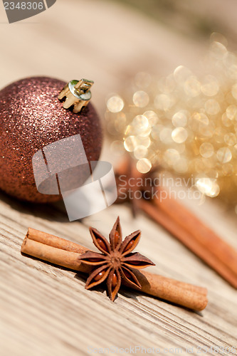 Image of anice cinnamon and bauble christmas decoration in gold