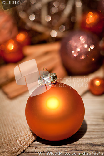 Image of glittering christmas decoration in orange and brown natural wood 