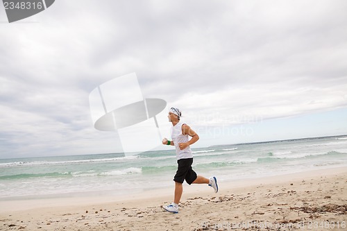 Image of man is jogging on the beach summertime sport fitness