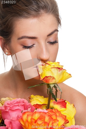 Image of attractive young smiling woman with flowers roses isolated
